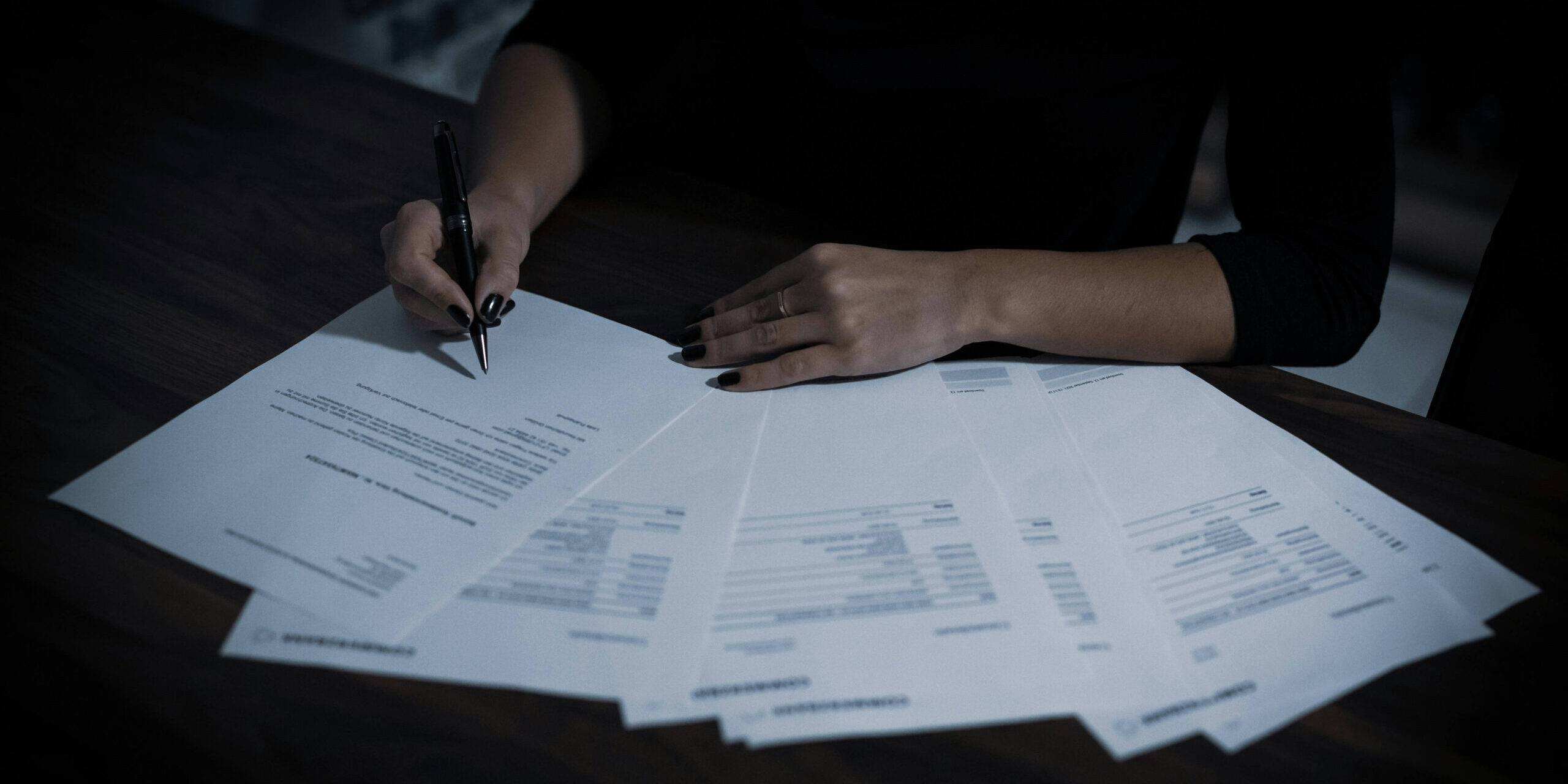 Person reviewing therapy benefits paperwork, out of network OCD treatment Denver CO